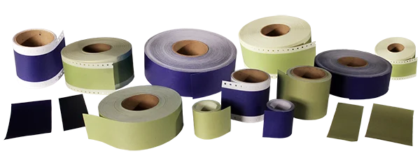 Various sizes of purple and green continuous feed labels on rolls