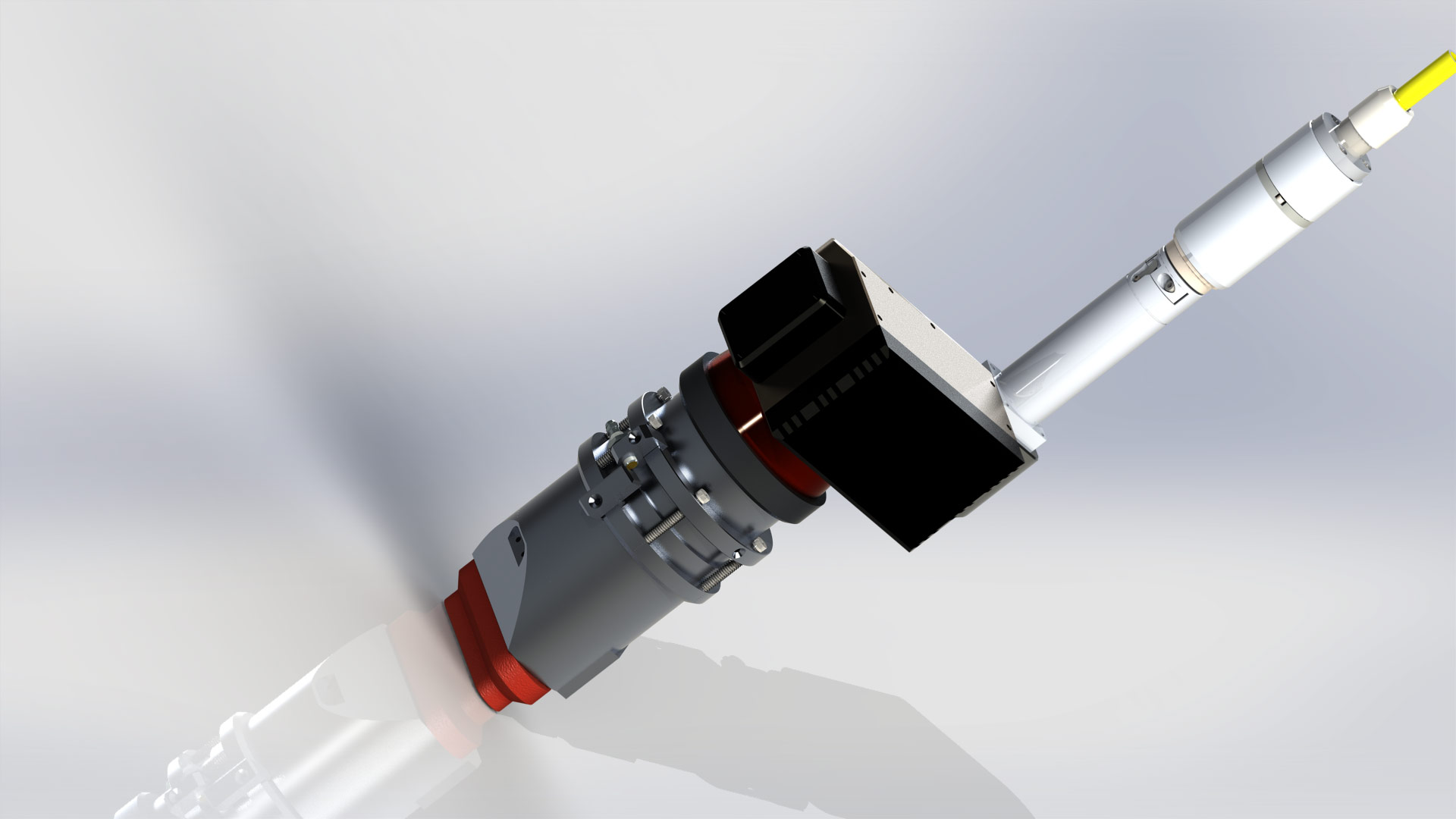 3D CAD model of a mechanical assembly featuring a cylindrical housing, a black control module, and a long probe-like extension with a yellow cable