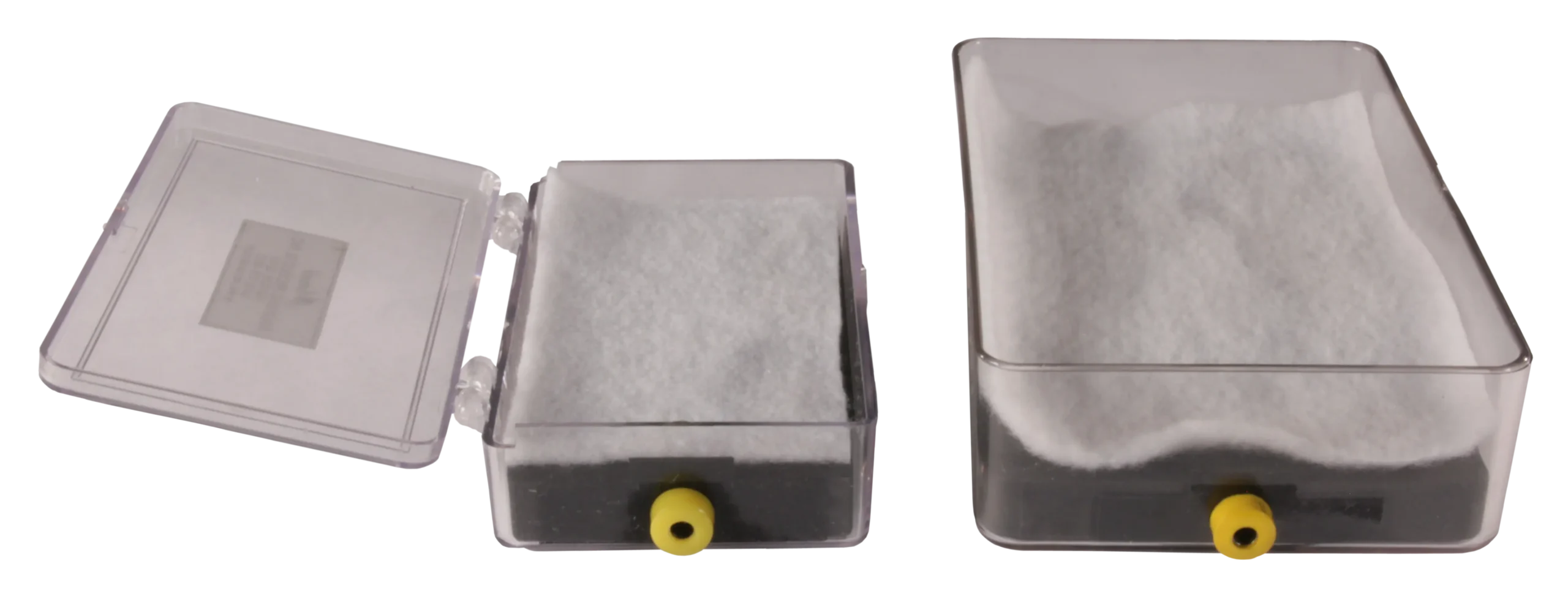 Two clear plastic boxes with white padding and yellow ports, one open and one closed