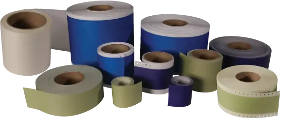 Various sizes of label rolls in white, blue, purple, and green