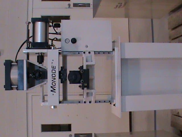 A Monode industrial marking machine mounted in an indoor facility